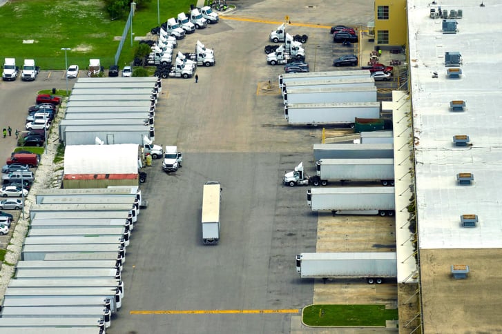 big-corporate-shipment-center-with-many-cargo-semi-trucks-unloading-uploading-retail-products-further-retail-shipment-global-market-concept (1)