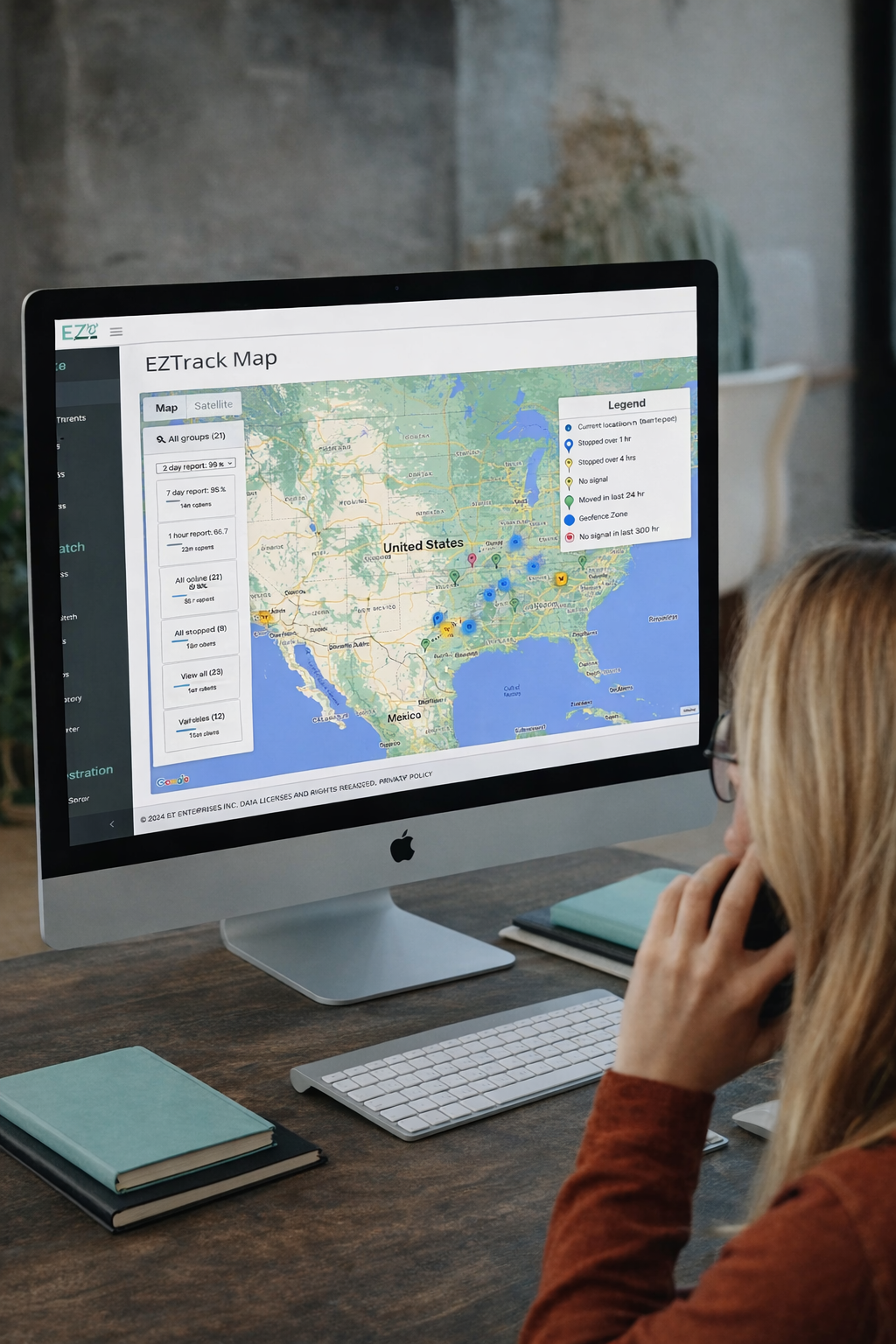a woman looking at a EZTrack asset tracking screen